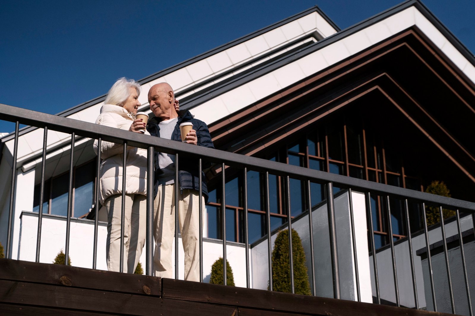 low angle senior couple with coffee cups 1